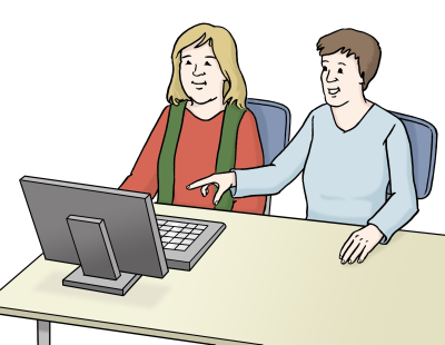 Zwei Personen sitzen vor einem Computer. Die eine Person zeigt der anderen Person etwas.